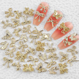 50Stück 3D Guld Sløjfe Nail Charms Butterfly Nail Art Charms Legierung Bogen Nagel Charms Nägel Zubehör Schleife Nagelschmuck Metall Schleifen Schmetterling Nageldesign Nagelanhänger Nailart Strasssteine